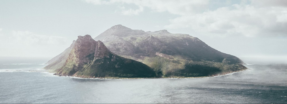 Mountainous island surrounded by water