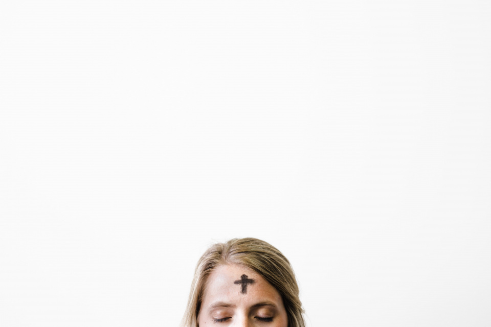 woman with ashes in the shape of a cross on her forehead