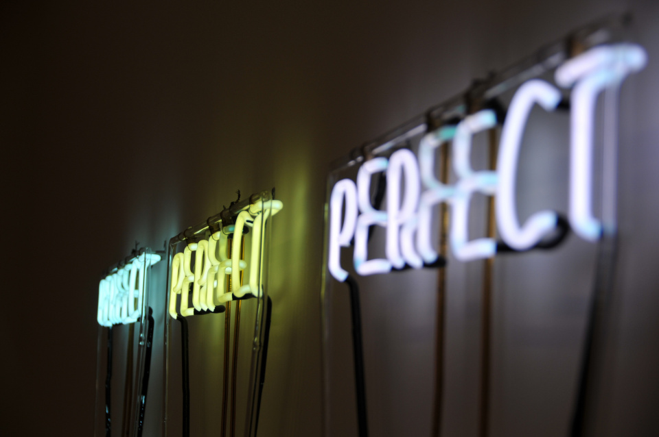 three neon signs that say "perfect" in a row