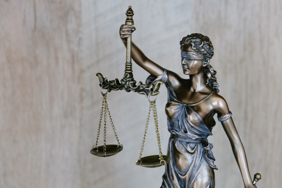 A statue of Lady Justice, blindfolded and holding equally weighted scales