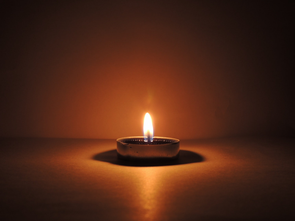 Candle brightening up a dark scene