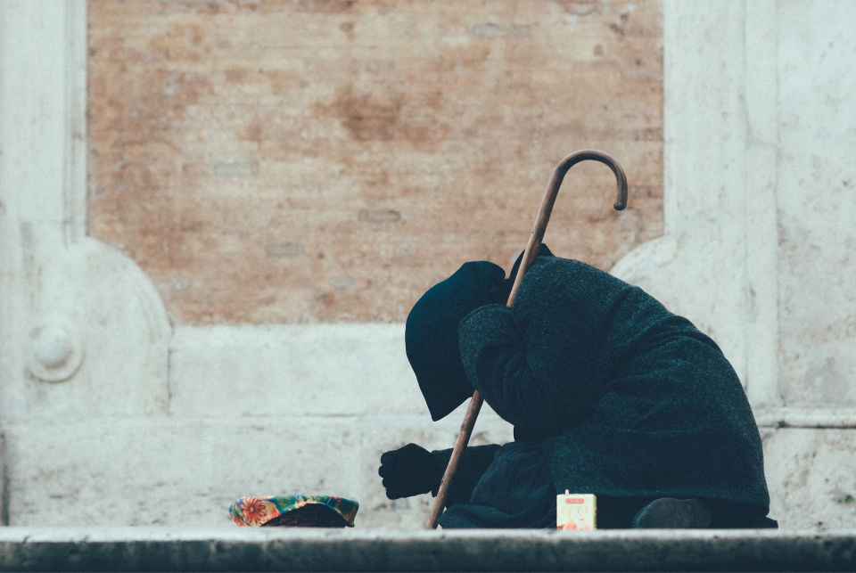 A beggar on the steps of a temple in Rome