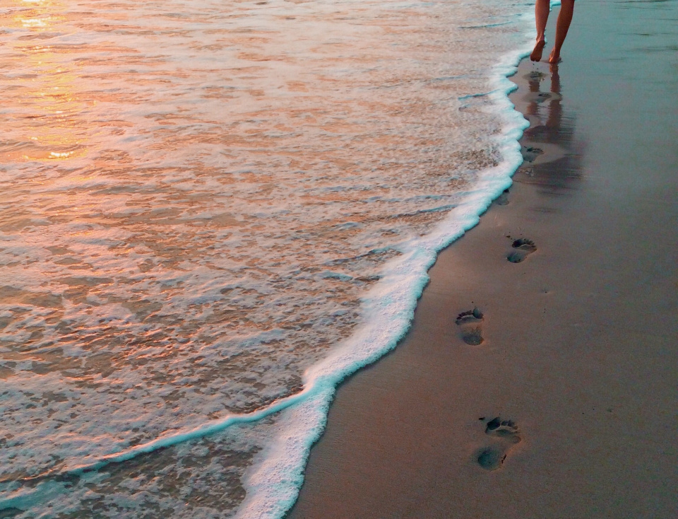 footsteps near an ocean 