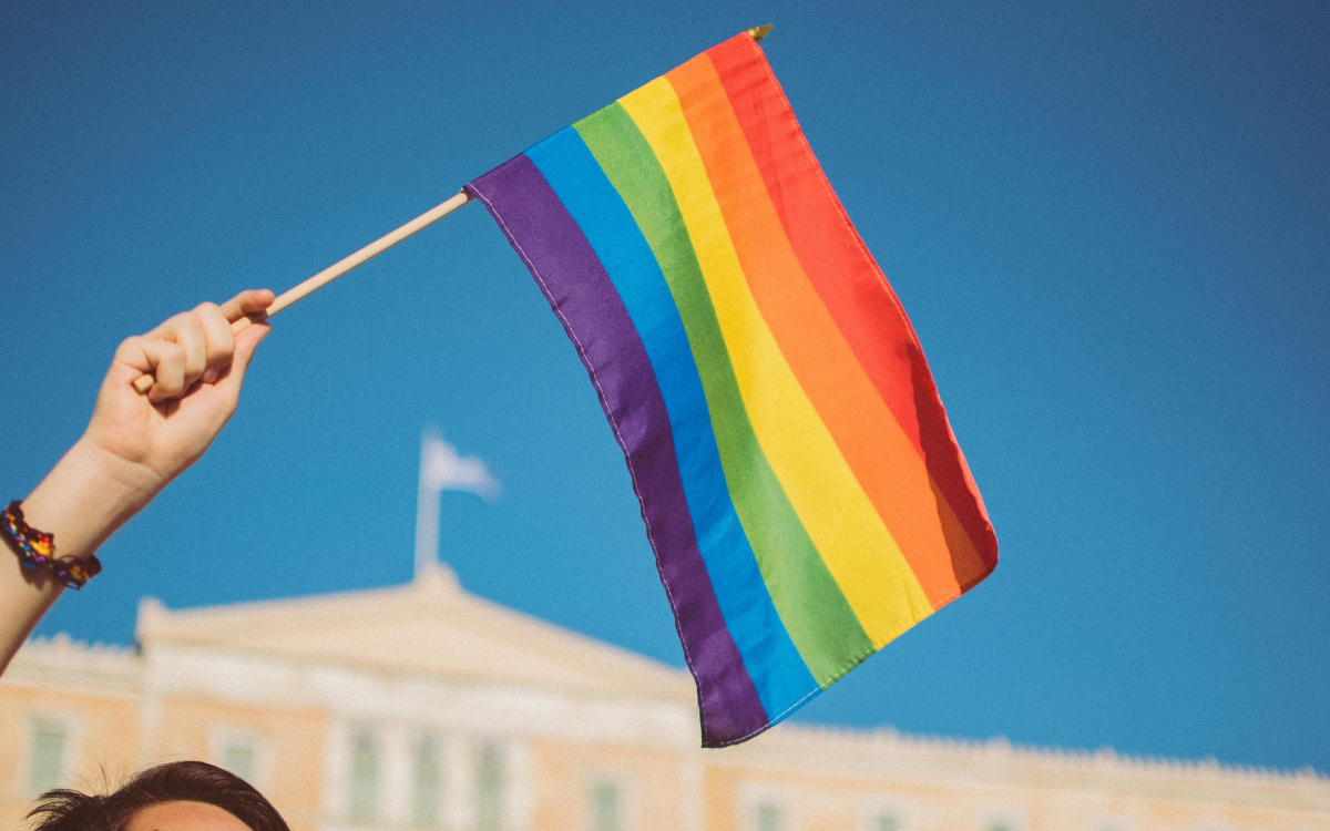 Pride flag being waved in the air