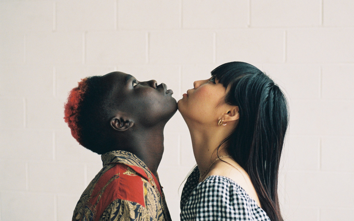 Two people looking up while their chins touch